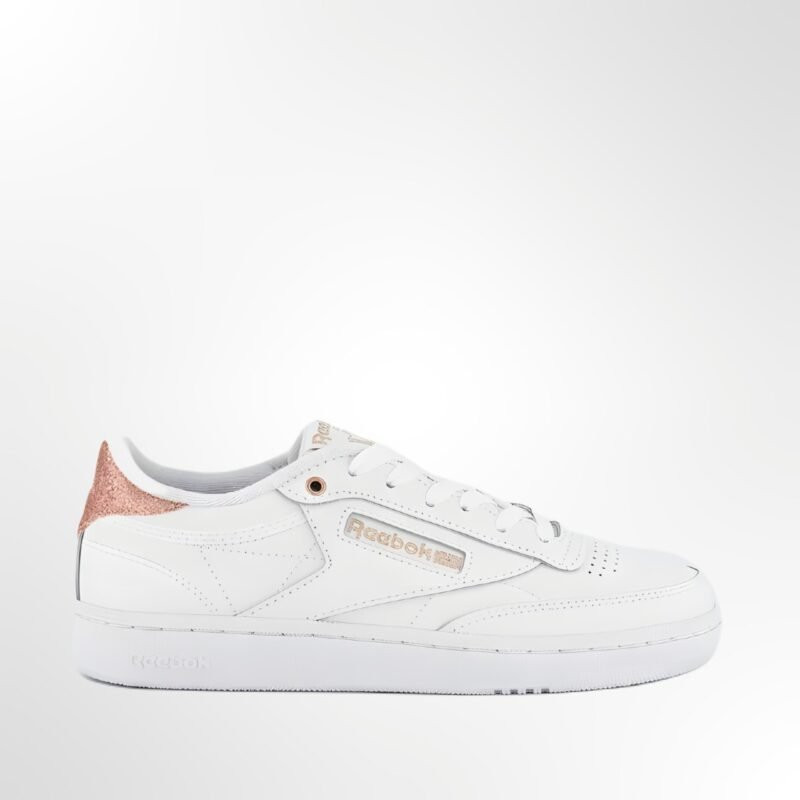 A side view of the Reebok Women's Club C 85 Sneakers in white, showcasing the classic low-cut design and elegant rose gold branding