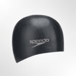 A close-up of the black swimming cap's surface, showing the smooth, silicone texture