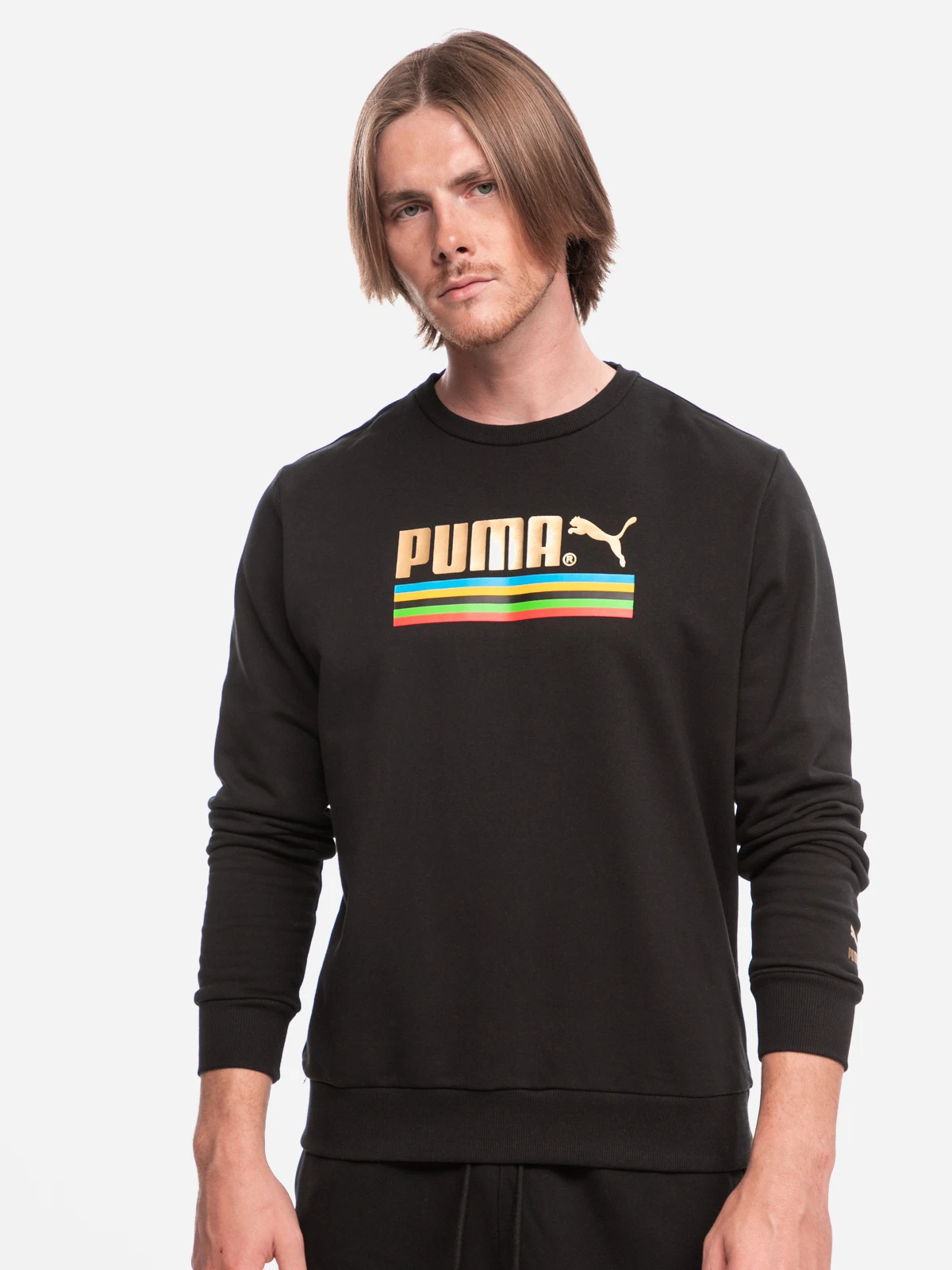 pm-59809101-1 A man wearing the Puma TFS WH Crew Sweatshirt in Puma Black, showcasing its comfortable, casual street styl